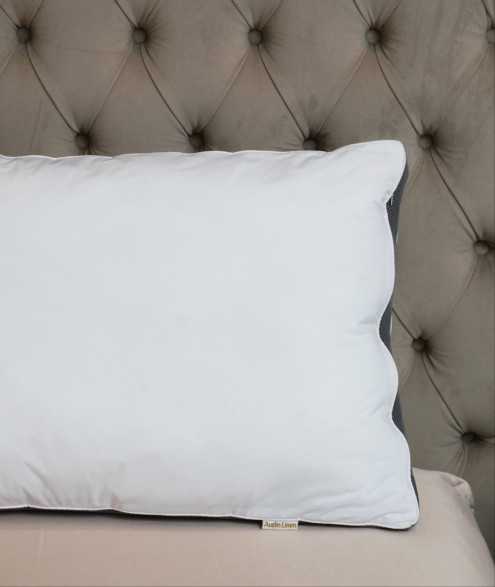 White pillow on a tufted headboard