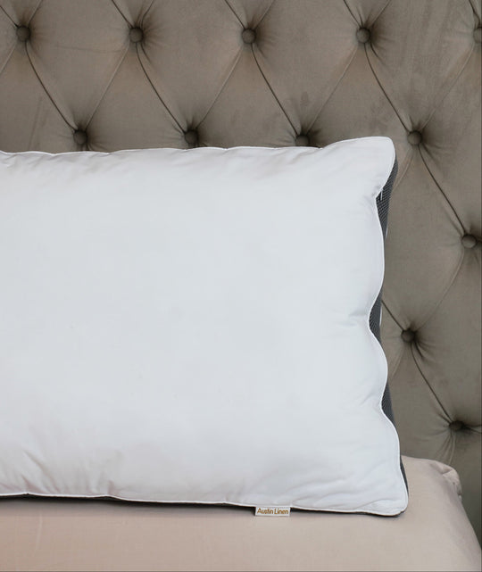 White pillow on a tufted headboard
